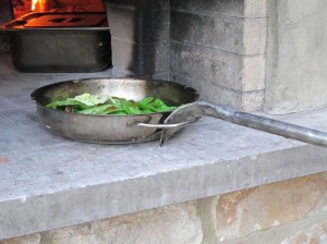 Use the Time to Heat a Wood-fired Pizza Oven to sauté veggies.  
