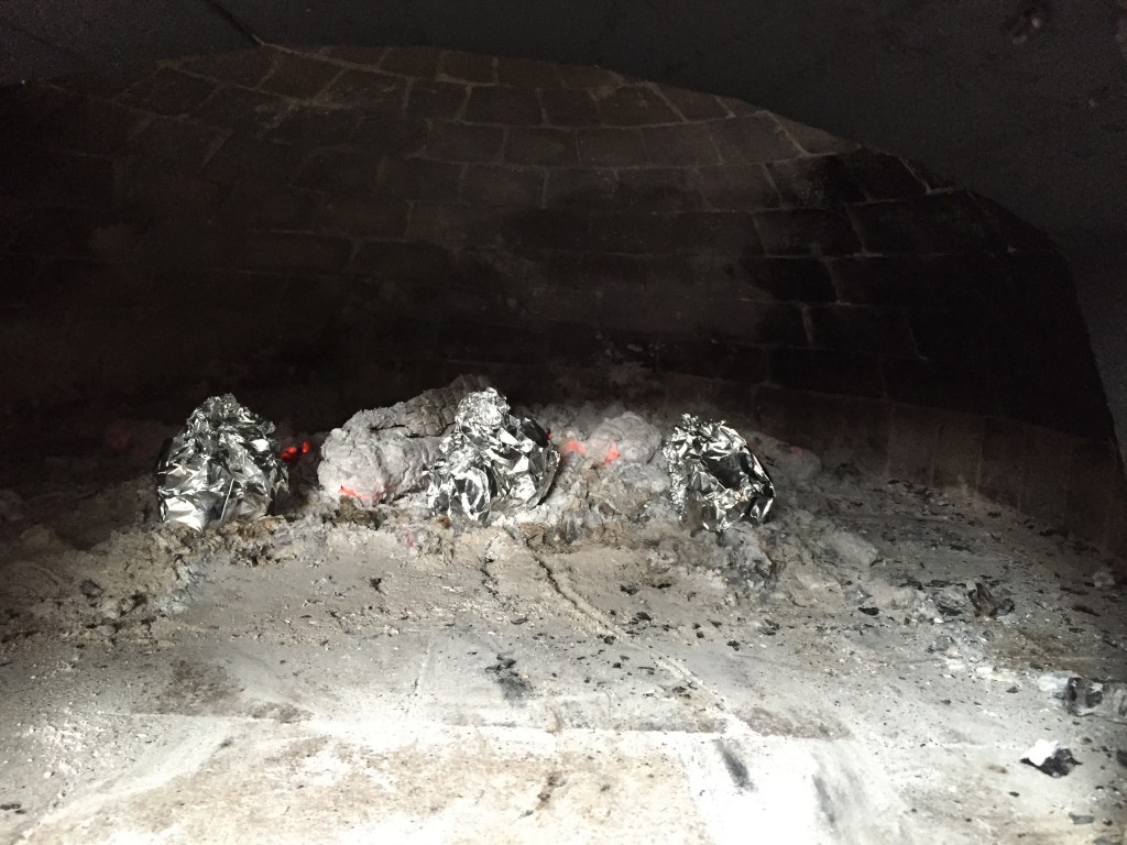 Bake potatoes among the dying coals of a fire, or with the residual heat in an oven on the down-cycle.