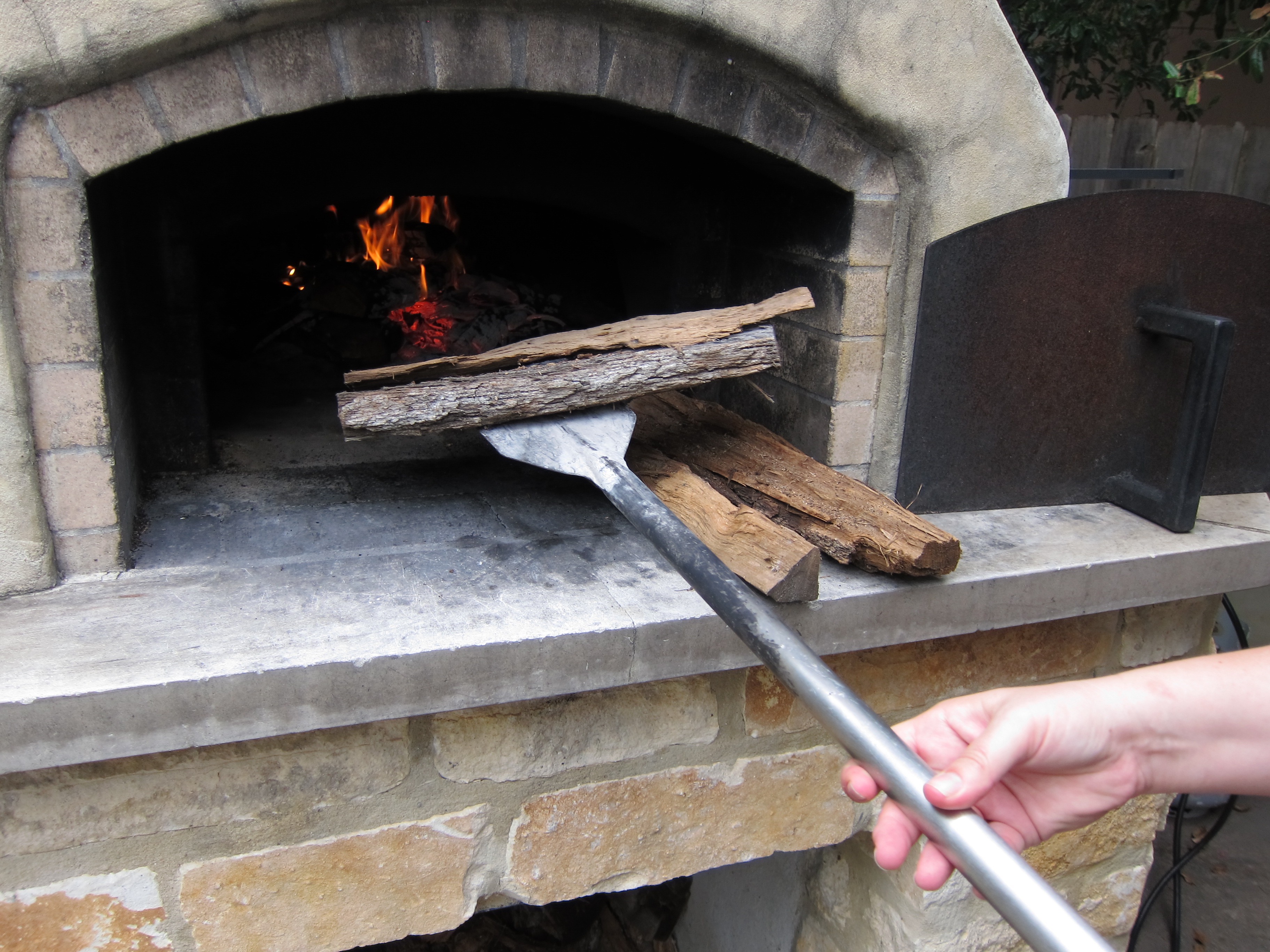 http://texasovenco.com/wp-content/uploads/2015/08/pizza-oven-tool-adding-wood-paddle-1153.jpg