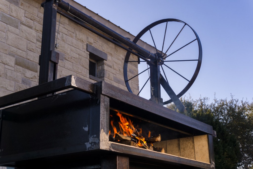 adjustable surface on wood-fired grill argentinian grill