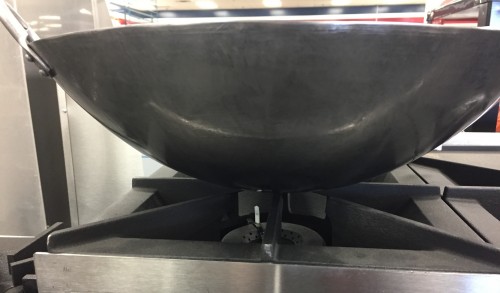 wok pan has minimal surface area in contact with conventional stove top