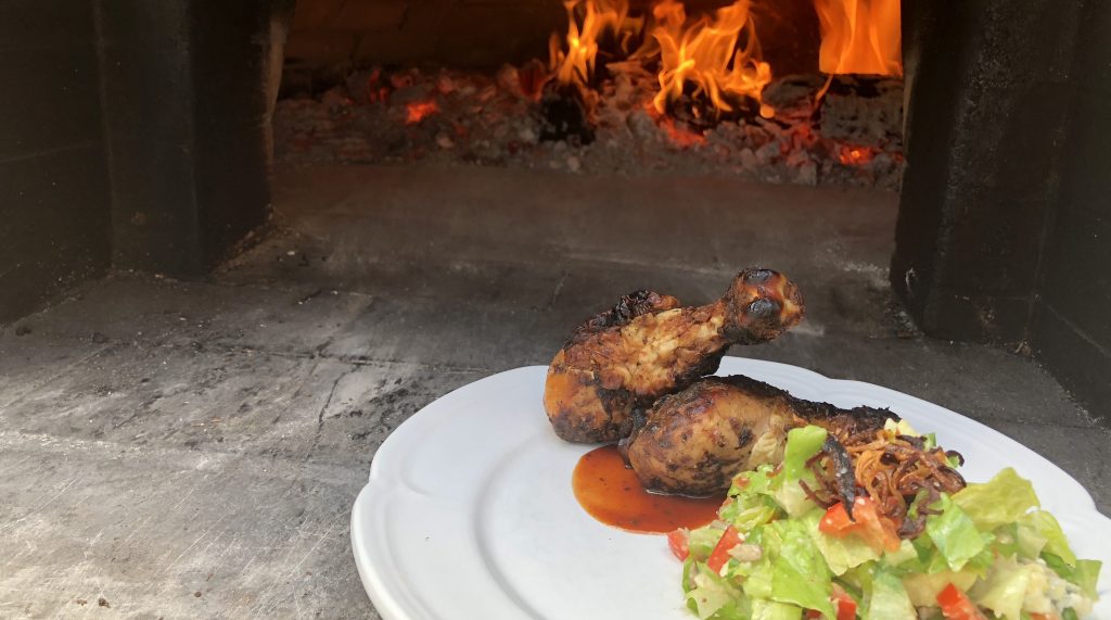 chicken drumsticks in wood burning oven pizza oven