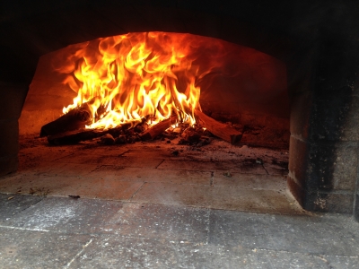 Add wood to pizza oven